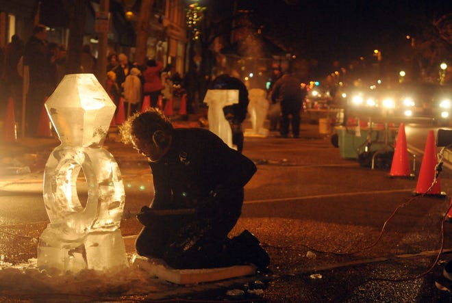 Paul Nuznov carves ice during the Holland Ice Sculpting Competition on 8th street in this file phtoo. FILE PHOTO/SENTINEL STAFF