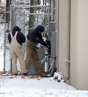 Photo by Daniel Freel/New Jersey Herald Electricians work at a utility box on the outside of the Hopatcong Board of Education administration building Wednesday after an electrical fire earlier in the morning.