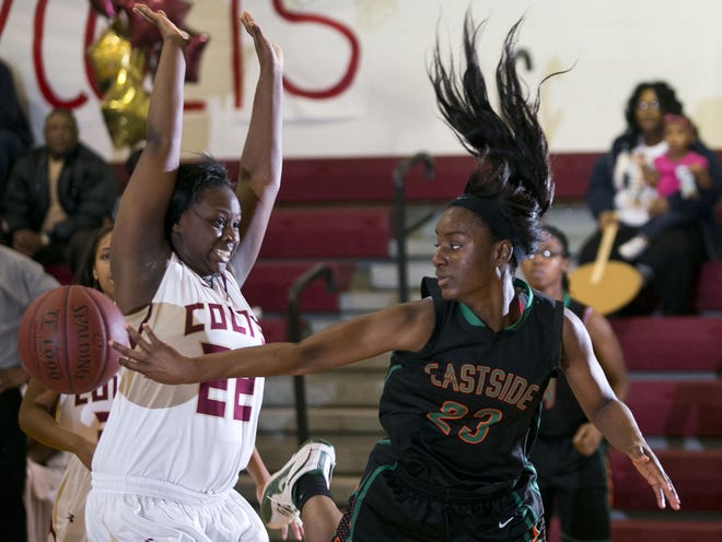 Eastside's Naiesha Baker tries to pass the ball around North Marion's Cecili Jamerson on Thursday in Sparr.