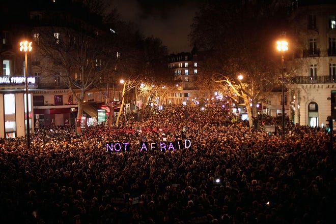 A huge throng gathered in Republique Square in Paris Wednesday night to pay respect to the victims of a terror attack against a satirical newspaper and to declare they were “not afraid.”