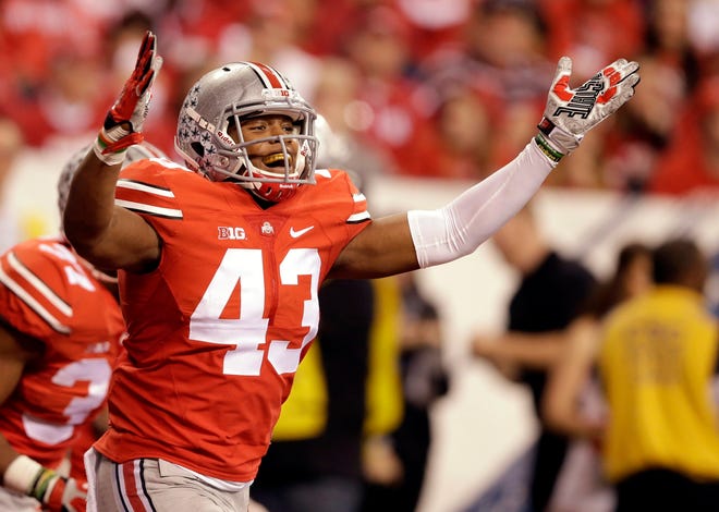 Ohio State linebacker Darron Lee and his Buckeyes teammates are almost a touchdown underdog against Oregon for Monday night's championship game. (AP Photo/Darron Cummings, File)