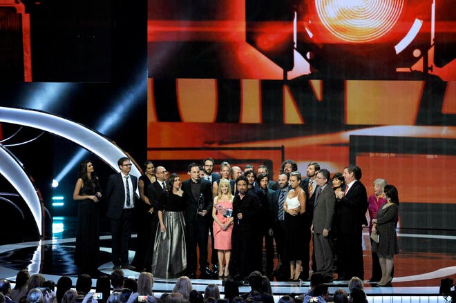 Johnny Galecki, center, and the cast and crew of 'The Big Bang Theory' accept the award for favorite TV show at the People's Choice Awards at the Nokia Theatre on Wednesday, Jan. 7, 2015, in Los Angeles.