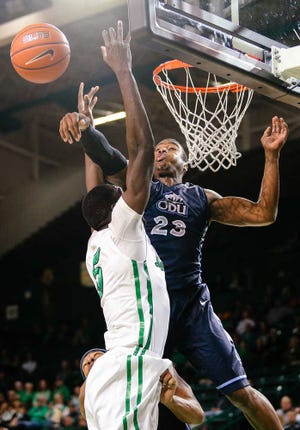 Old Dominion's Richard Ross, right, blocks a dunk attempt by Marshall's Cheikh Sane (5) during an NCAA college basketball game Thursday, Jan. 8, 2015, at the Cam Henderson Center in Huntington, W.Va. (AP Photo/The Herald-Dispatch, Sholten Singer)