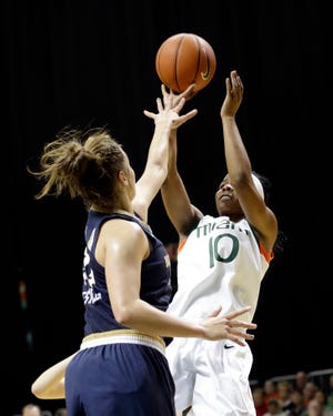 Miami guard Michelle Woods, right, scored nine points to help Miami defeat No. 4 Notre Dame, 78-63, on Thursday. The Associated Press.