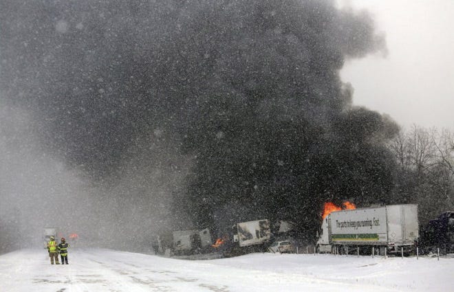 Emergency personnel work at the scene of a fiery crash that closed both sides of Interstate 94 between mile markers 88 and 92 in eastern Kalamazoo County, near Galesburg, Mich.