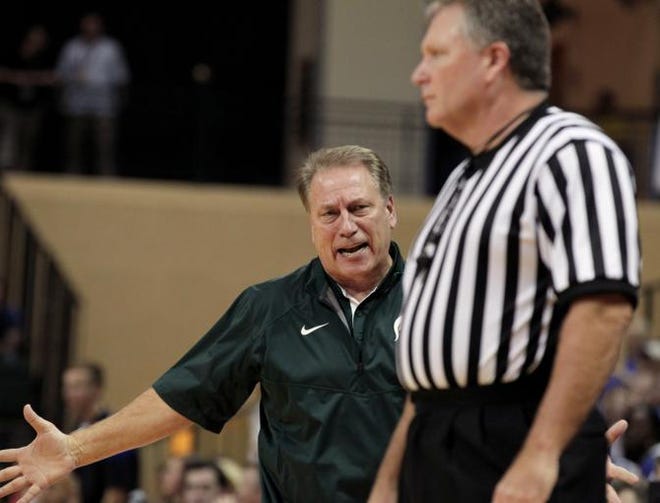 Michigan State head coach Tom Izzo, left, talks to referee Karl Hess during the second half of an NCAA college basketball game in Lake Buena Vista, Fla., Sunday, Nov. 30, 2014. Kansas won 61-56.