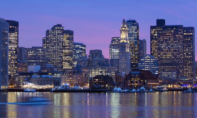 In this 2012 file photo, the Boston city skyline is illuminated at dusk as it reflects off the waters of Boston Harbor. The U.S. Olympic Committee picked Boston as its bid city for the 2024 Summer Games. The city will be presented to the International Olympic Committee for a vote in 2017. Rome also is in the bidding, along with Hamburg or Berlin, Germany. France and Hungary also are considering bids. Michael Dwyer/Associated Press file