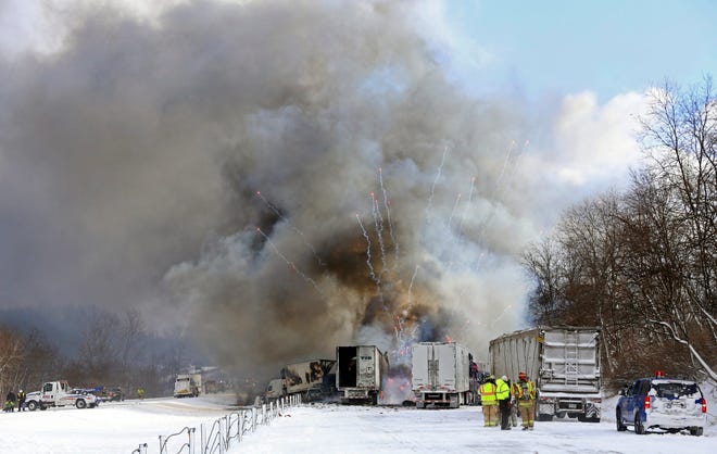 Emergency personnel watch as fireworks ignite at the scene of a fiery crash that closed both sides of Interstate 94, Friday, Jan. 9, 2015, between mile markers 88 and 92 in eastern Kalamazoo County, near Galesburg. AP Photo/Kalamazoo Gazette-MLive Media Group, Mark Bugnaski