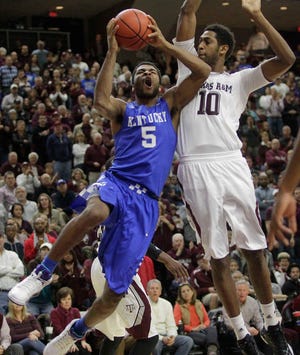 Kentucky's Andrew Harrison (5) takes a shot over Texas A&M's Jordan Green (10) during the second half of an NCAA college basketball game Saturday, Jan. 10, 2015, in College Station, Texas. (AP Photo/Patric Schneider)