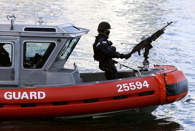 A U.S. Coast Guard boat patrols Boston Harbor outside the federal courthouse on Monday. The courthouse was under tight security with dozens of police officers inside and outside the building. Michael Dwyer/The Associated Press