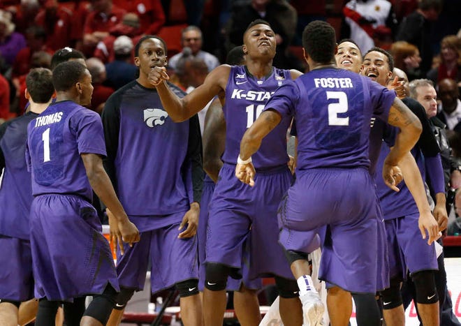 Kansas State's Jevon Thomas (1), Malek Harris (10) and Marcus Foster (2) celebrate after defeating Oklahoma in an NCAA college basketball game in Norman, Okla., Saturday, Jan. 10, 2015. Kansas State won 66-63, in overtime.