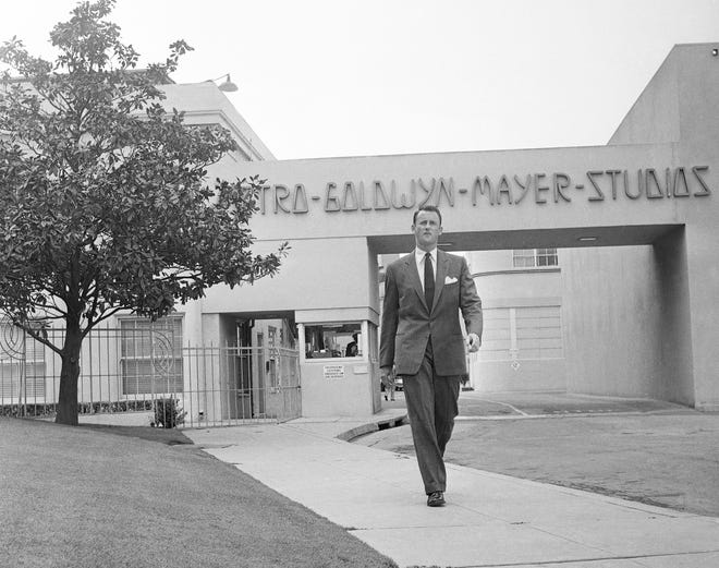 FILE - In this April 22, 1959, file photo, Samuel Goldwyn, Jr., poses outside the main gate at Metro-Goldwyn-Mayer studios in the Hollywood section of Los Angeles. Goldwyn Jr., a champion of the independent film movement and son to one of the founding fathers of Hollywood cinema, died died Friday, Jan. 9, 2015, from congestive heart failure, his son told the Los Angeles Times. He was 88. (AP Photo/Ellis R. Bosworth, File)