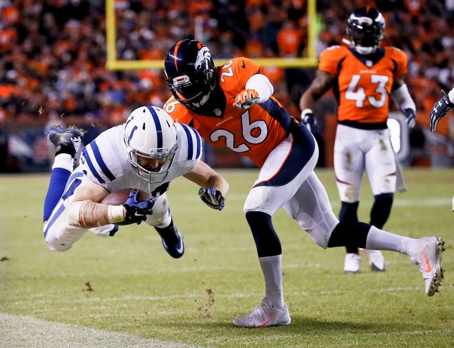 Indianapolis Colts tight end Jack Doyle, left, is knocked out of bounds by Denver Broncos free safety Rahim Moore during the second half of an NFL divisional playoff football game, Sunday, Jan. 11, 2015, in Denver.