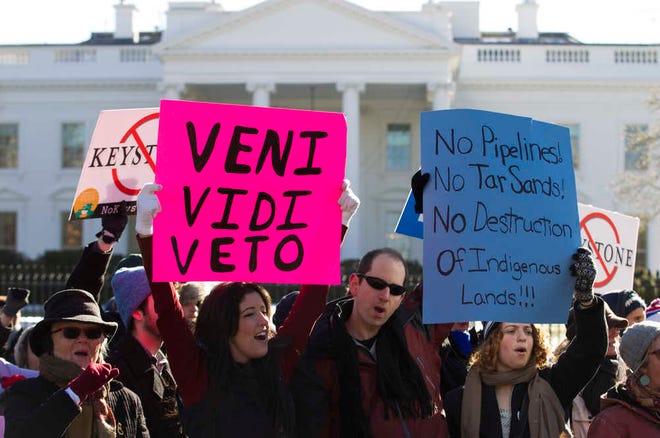 Dozens of demonstrators rally in support of Obama's pledge to veto any legislation approving the Keystone XL pipeline, outside the White House in Washington on Saturday, Jan. 10, 2015. (AP Photo/Jose Luis Magana)