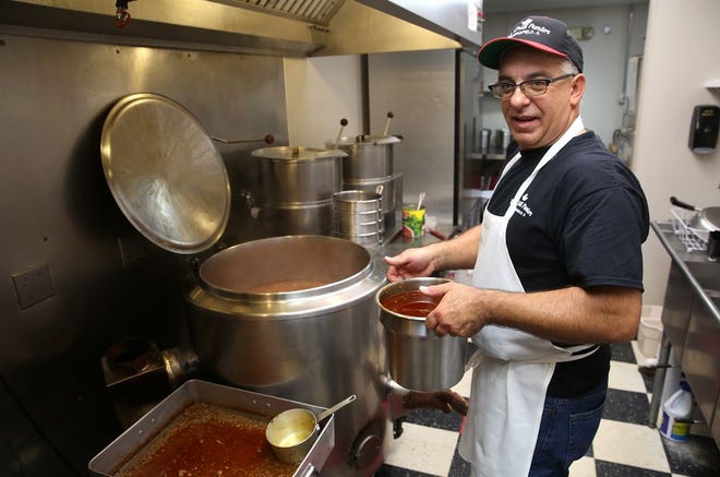 Retired Springfield firefighter David Hollis, who is Marianne Rogers' son-in-law, is head chili cook at The Chili Parlor. At left in background is the “big bean pot,” a steam-jacketed cooker that can hold nearly 30 gallons of beans at a time.