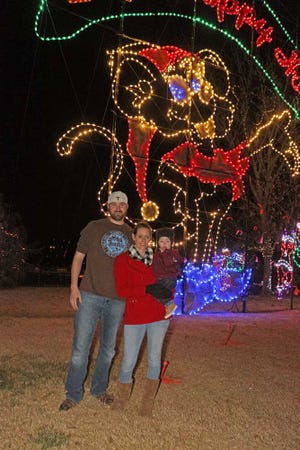 Tony, from left, Charity and Deklyn Hoover check out the light displays at Amarillo Zoo Lights Safari.