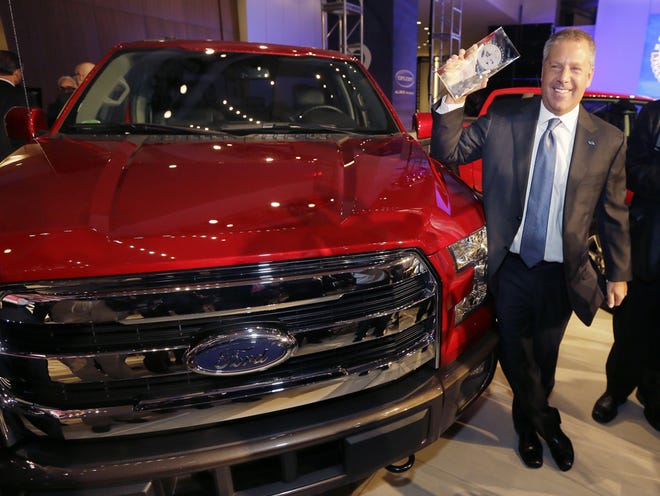 Joe Hinrichs, Ford executive vice president and president, the Americas, poses with the Ford F-150 truck after winning the North American Truck of the Year during the North American International Auto Show, Monday in Detroit.