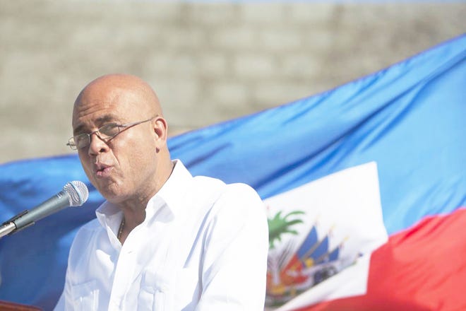 HAITI'S PRESIDENT MICHEL MARTELLY speaks Monday during a memorial service for victims of the earthquake in January 2010 at Titanyen, a mass burial site north of Port-au-Prince, Haiti. Somber Haitians gathered early Monday to remember the devastating earthquake that left much of the capital and surrounding area in ruins in one of the worst natural disasters of modern times.