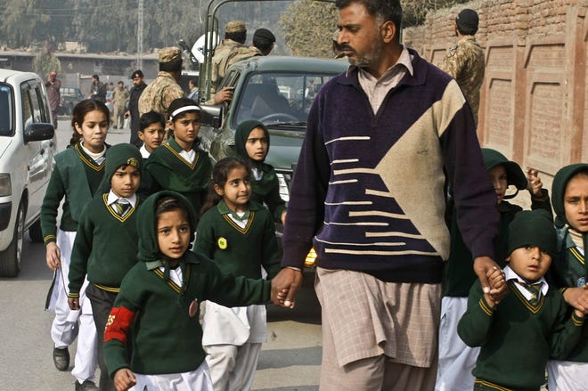 A plainclothes security officer escorts students evacuated from a school as Taliban fighters attack another school nearby, killing more than 100 people, mostly children, in Peshawar, Pakistan, Tuesday, Dec. 16, 2014. U.S. Secretary of State John Kerry condemned the attacks: "Mothers and fathers send their kids to school to learn and to be safe and to dream and to find opportunity. And particularly at this military school in Pakistan, they sent their kids there with the hope and dreams of serving their country. Instead, today they are gone, wiped away by Taliban assassins who serve a dark and almost medieval vision, and the opposite of everything that those mothers and fathers wanted for their children."