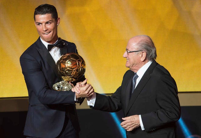 Cristiano Ronaldo, left, of Portugal is congratulated by FIFA President Sepp Blatter after winning the FIFA Men's soccer player of the year 2014 prize at the FIFA Ballon d'Or awarding ceremony at the Kongresshaus in Zurich, Switzerland, Monday, Jan. 12, 2015. (AP Photo/KEYSTONE,Ennio Leanza)