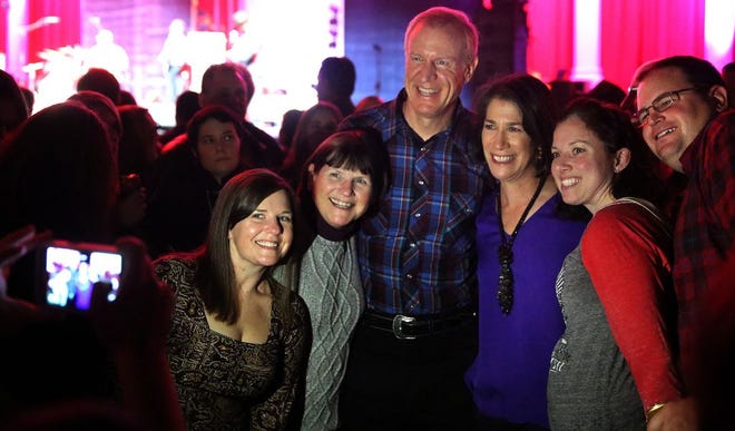 Gov. Bruce Rauner and wife Diana pose for photos with some of those attending the Inauguration Day concert during the Buddy Guy set on Monday, Jan. 12, 2015.