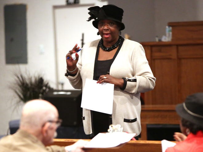 Evelyn Foxx, president of the Alachua County branch of the NAACP, talks with citizens during a community meeting about an assistant city manager who the citizens believe has posted racially insensitive comments on his personal Facebook page, at the Archer Church of God in Christ, in Archer on Monday.
