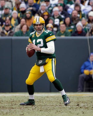 Green Bay Packers quarterback Aaron Rodgers (12) looks for an open receiver during the first half of an NFL divisional playoff football game against the Dallas Cowboys Sunday, Jan. 11, 2015, in Green Bay, Wis. (AP Photo/Nam Y. Huh)