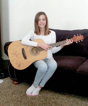 Nearly two weeks after winning her prize Lindsea Taylor finally held her guitar in her hands Monday, Jan. 12, 2015.