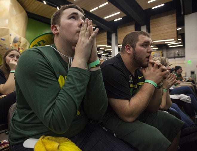 Will Talbot (left), a freshman at the University of Oregon, and Ken Haskett, a sophomore, react while watching the national championship game on campus. (Alan Sylvestre/For The Register-Guard)