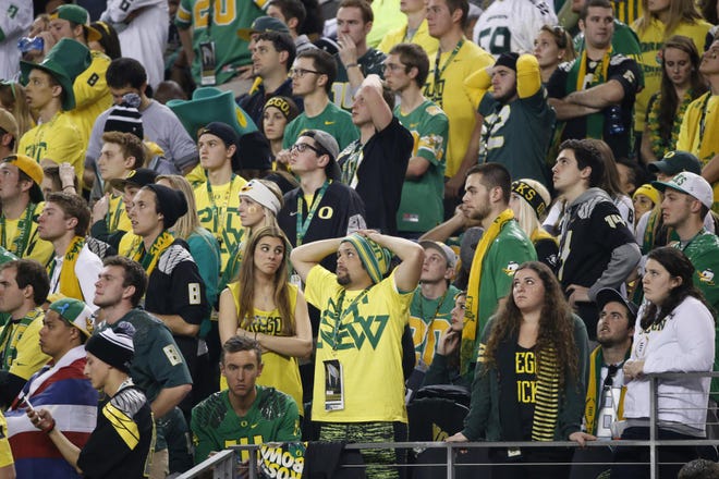 Oregon fans react to an Ohio State score in the the fourth quarter of the College Football Playoffs National Championship at AT&T Stadium in Dallas on Monday, January 12, 2015. (Andy Nelson/The Register-Guard)