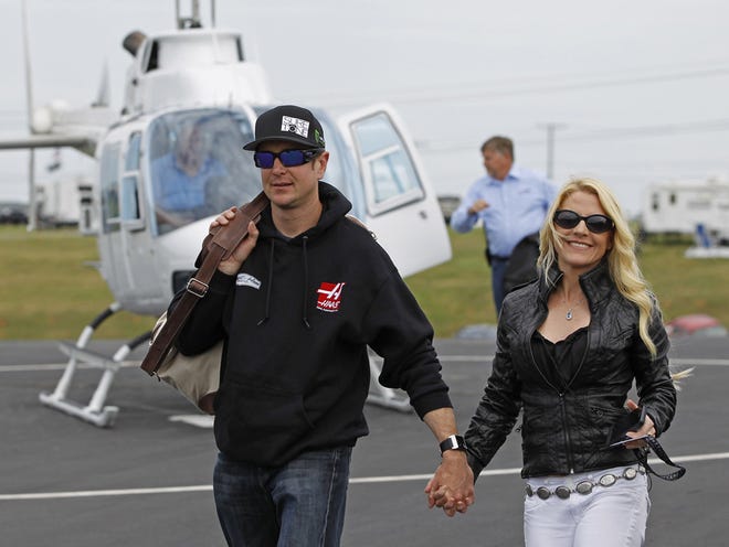 In this May 17, 2014 photo, Kurt Busch walks with his girlfriend, Patricia Driscoll, after arriving for the NASCAR Sprint All-Star auto race at Charlotte Motor Speedway in Concord, N.C. A hearing on Busch's ex-girlfriend's request for a no-contact order stemming from assault allegations resumed Monday in Dover, Del. Busch's attorneys have denied Driscoll's assault allegations and have tried to portray Driscoll as a scorned woman out to destroy Busch's career.