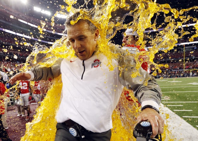 Ohio State head coach Urban Meyer is dunked during the NCAA college football championship game against Oregon on Monday in Arlington, Texas. Without the new playoff system, the Buckeyes would not have had a chance to play for, and win, a national title. Sharon Ellman/THE ASSOCIATED PRESS