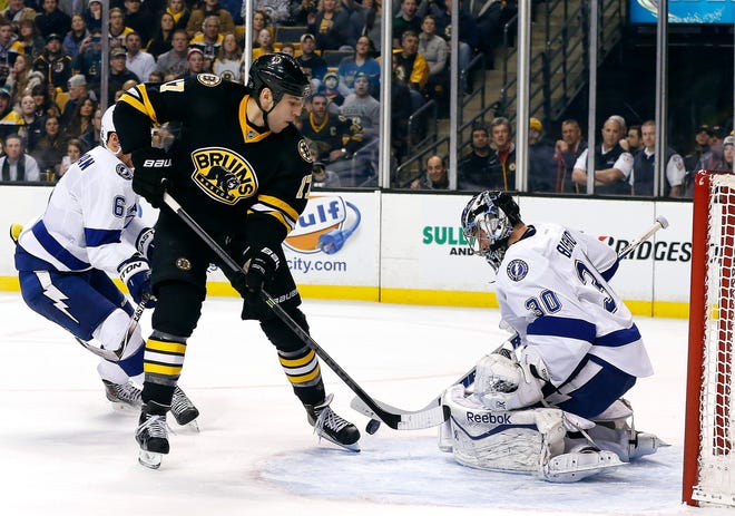 Boston’s Milan Lucic scores past Tampa Bay goalie Ben Bishop Tuesday during the Bruins’ 4-3 win. THE ASSOCIATED PRESS
