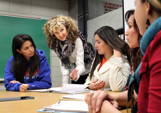 Teresa Drake, center, director of the Intimate Partner Violence Assistance Clinic, works with a group of her students at the Virgil Hawkins Civil Clinics at the UF Levin College of Law in Gainesville Dec. 9, 2014.