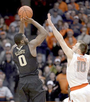 Wake Forest's Codi Miller-McIntyre (left) shoots against Syracuse's Trevor Cooney during the second half of Tuesday's game in Syracuse, N.Y. 



AP Photo/Kevin Rivoli