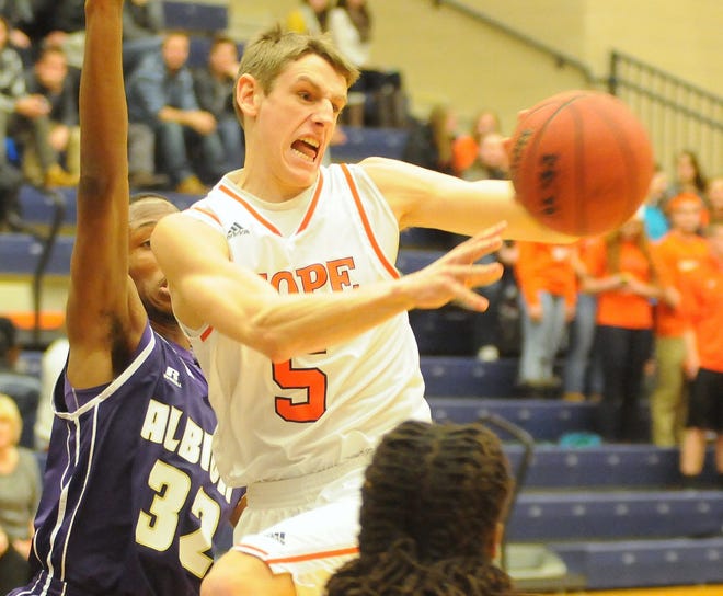 Hope's Cody Stuive passes the ball against Albion on Wednesday at DeVos Fieldhouse. Dan D'Addona/Sentinel staff