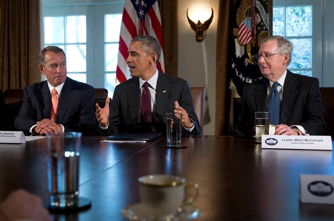 President Barack Obama, flanked by House Speaker John Boehner of Ohio, left, and Senate Majority Leader Mitch McConnell of Ky., speaks to media as he meets with bipartisan, bicameral leadership of Congress to discuss a wide range of issues, Tuesday, Jan. 13, 2015, in the Cabinet Room of the White House in Washington. (AP Photo/Carolyn Kaster)