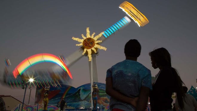 A couple enjoys the sights at the South Florida Fair in 2014.