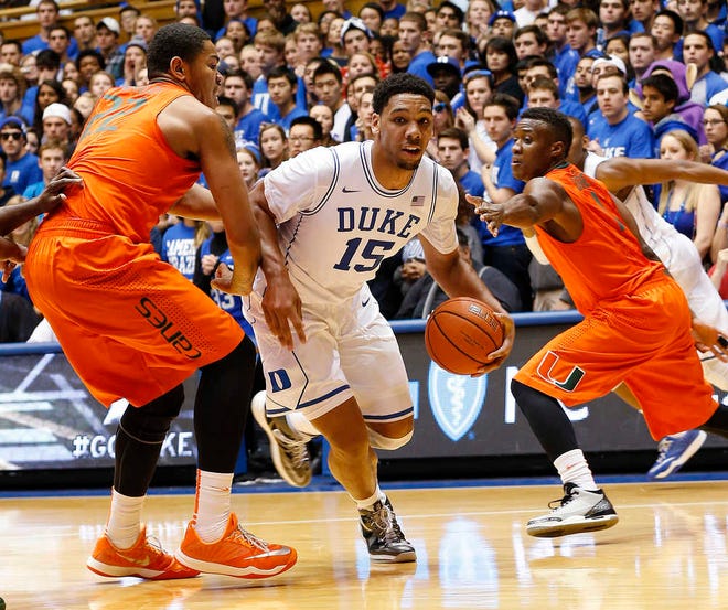 CORRECTS YEAR - Duke's Jahil Okafor (15) goes to the basket against Miami's Omar Sherman, left, and Deandre Burnett, right, during the first half of an NCAA college basketball game Tuesday, Jan. 13, 2015, in Durham, N.C. (AP Photo/Ellen Ozier)
