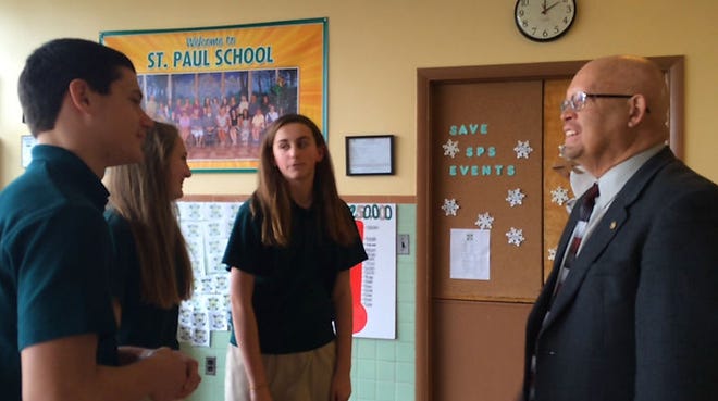 Eighth graders Joseph Levach, Jillian Stankiewicz, and Brooke Richards talk with Principal William Robbins of St. Paul School.