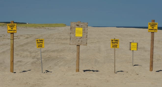 Several signs were placed at the border between Orleans and Eastham on Nauset spit last year after Eastham officials voted to ban driving on the portion of the spit that now extends into their town. Orleans selectmen have now voted to appeal that decision by the Eastham Conservation Commission. Merrily Cassidy/Cape Cod Times file