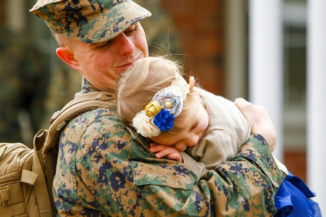 Staff Sgt. Chris Caulder gets hug from his daughter Madison Caulder, 2, after returning with the 26th Marine Expeditionary Unit at Camp Lejeune Thursday morning.