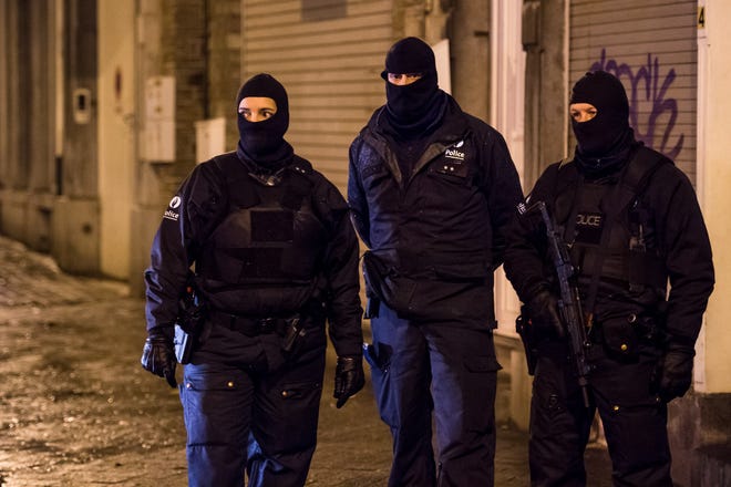 Belgian police officers guard a street in Verviers, Belgium, Thursday, Jan. 15, 2015. Belgian authorities say two people have been killed and one has been arrested during a shootout in an anti-terrorist operation in the eastern city of Verviers.