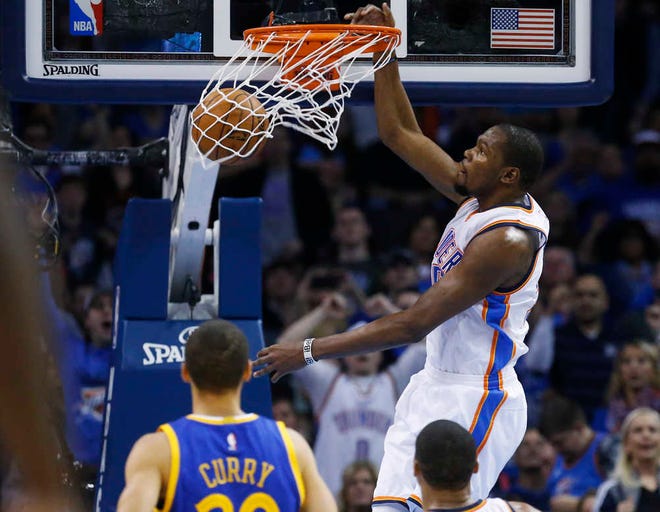 Oklahoma City's Kevin Durant dunks during the second quarter against Golden State. He finished with 36 points and nine boards in the Thunder's 127-115 win over the Warriors.