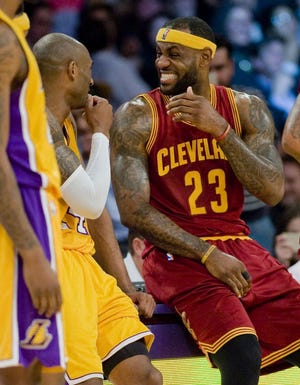 LeBron James of the Cavaliers, right, shares a laugh with the Lakers' Kobe Bryant.