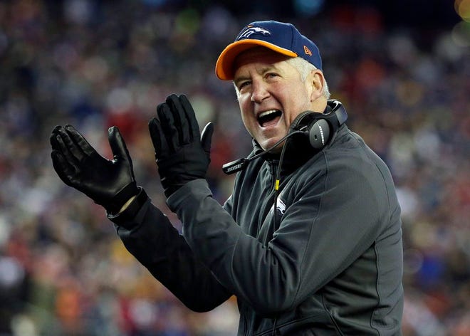 In this Nov. 2, 2014, file photo, then-Denver Broncos head coach John Fox cheers for his team from the sideline against the New England Patriots in the first half an NFL football game in Foxborough, Mass. The Chicago Bears have reached an agreement with John Fox to become the teams head coach, Friday, Jan. 16, 2015.