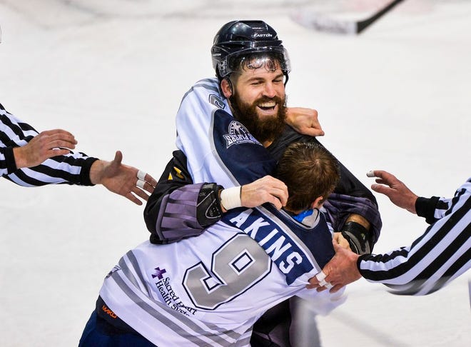 Dennis Sicard of the Peoria Rivermen smiles as he fights with Drew Akins of the Pensacola Flyers in the second period of d an SPHL game on Nov. 29 at Carver Arena.