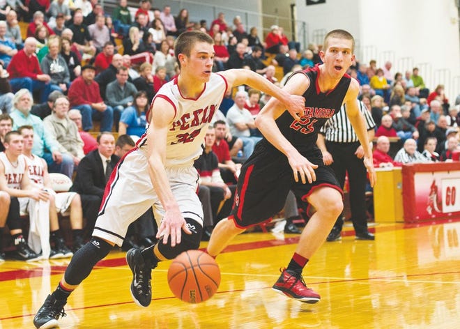 Pekin's Austin Juergens moves towards the hoop while Metamora's Nate Kennell defends during their game Friday at Pekin Community High School.