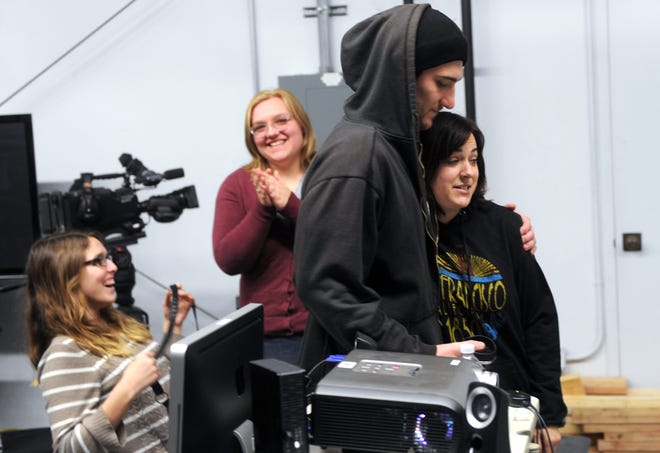 Tyler Graham hugs Brianna Torres, both San Joaquin Delta College television students, after screening their sitcom Thursday, which they help produced.  CALIXTRO ROMIAS/THE RECORD