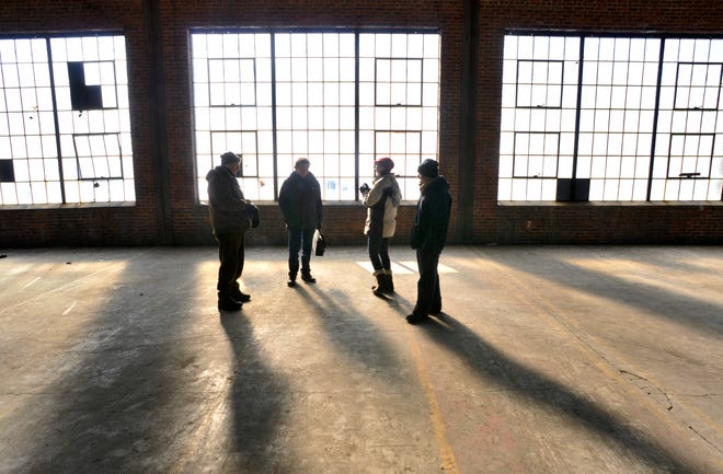 From left, architect Thomas Carey, Community Design Partnership principal Jonathan Seward, Worcester Artist Group board member Angela Pasceri and Worcester Artist Group CEO Randolph Gardner tour the large vacant building at 40 Pullman St. in Worcester on Jan. 13. WAG is proposing a new makerspace complex in the building.